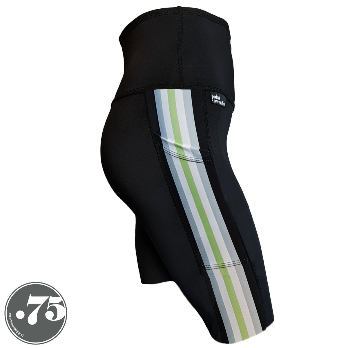 A pair of black spandex knee length shorts on a mannequin, the leggings have a 3.5” wide stripe down the side that has a printed fabric with vertical stripes in the colours of the Agender Pride Flag Black, Grey, White, Light Green, White Grey & Black.