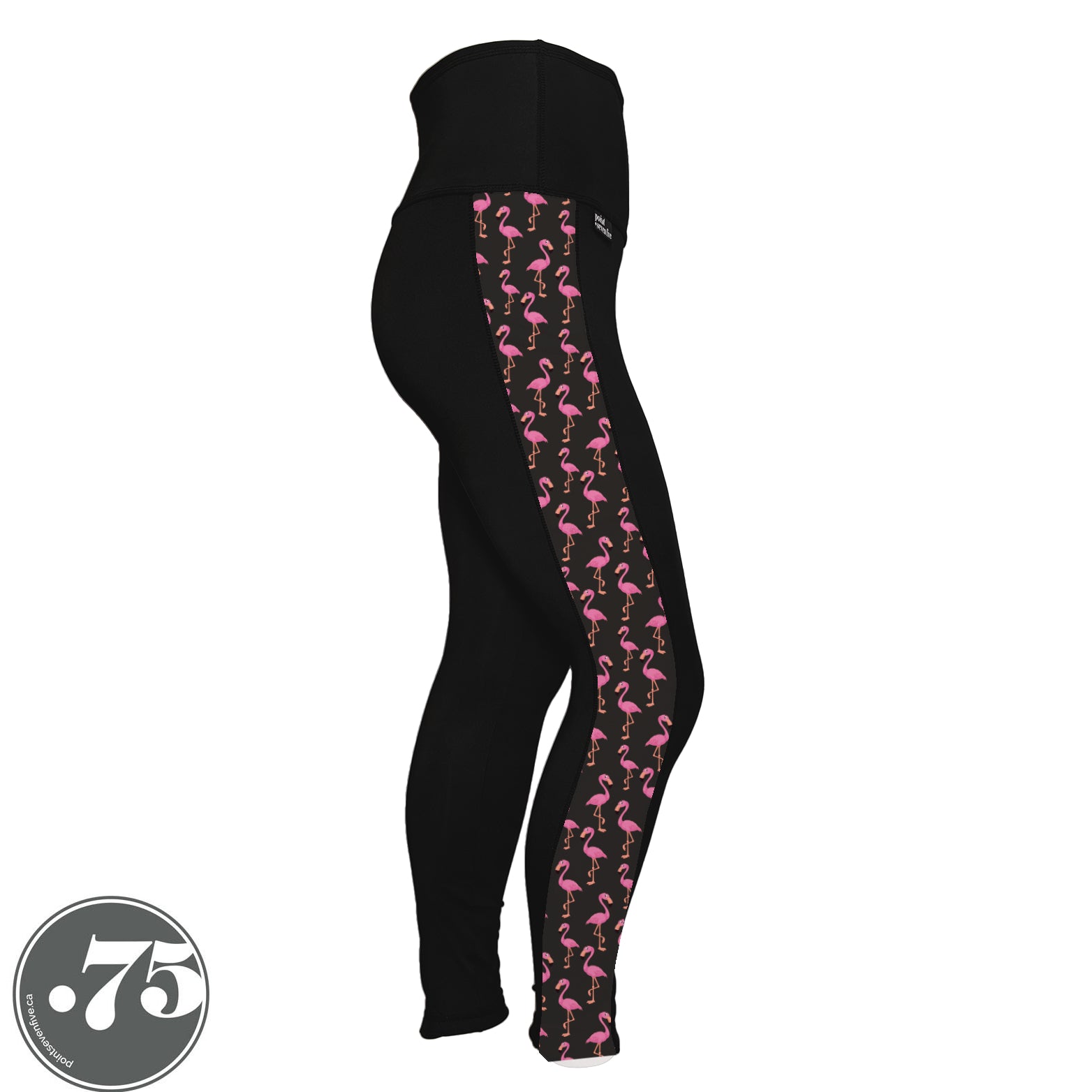 A pair of black spandex leggings against a white background. The leggings are full length and have a panel on the side with a pocket, the panel has fabric with a charcoal grey background with scattered cartoon pink flamingos on it.