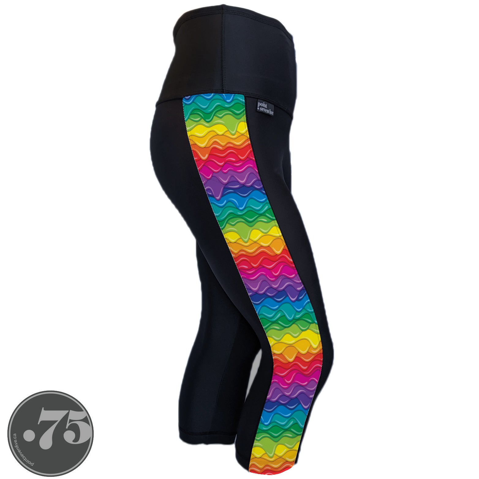 A pair of black spandex capri leggings against a white background. The leggings are calf length and have a panel on the side with a pocket, the panel has rows of dripping paint in different colours, red, pink, purple, blue, green, yellow and orange. 