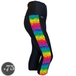 Load image into Gallery viewer, A pair of black spandex capri leggings against a white background. The leggings are calf length and have a panel on the side with a pocket, the panel has rows of dripping paint in different colours, red, pink, purple, blue, green, yellow and orange. 
