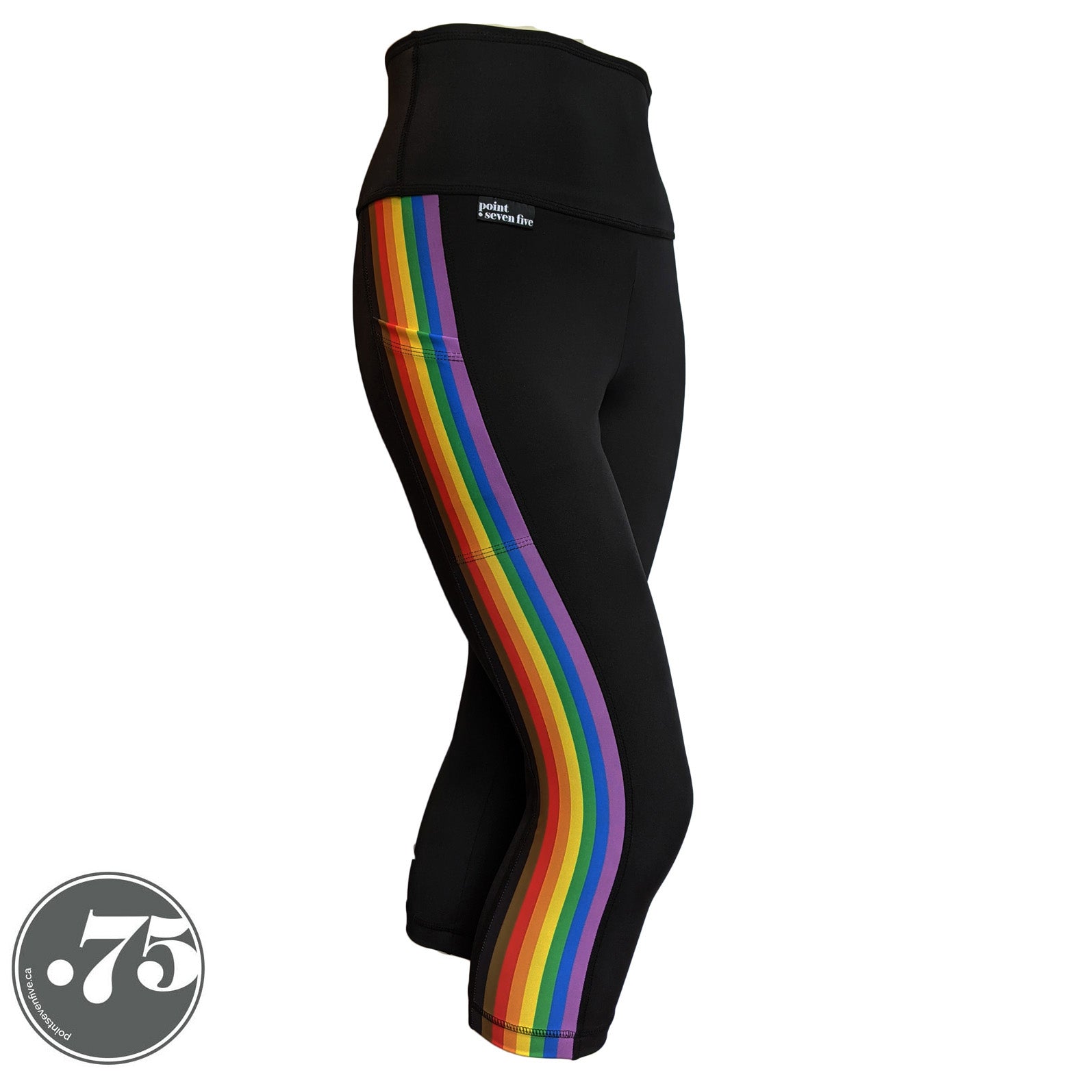 A pair of black spandex capri leggings on a mannequin, the leggings have a 3.5” wide stripe down the side that has a printed fabric with the stripes of the Philadelphia Pride Flag vertically, the stripes are black, brown, red, orange, yellow, green, blue & purple. 