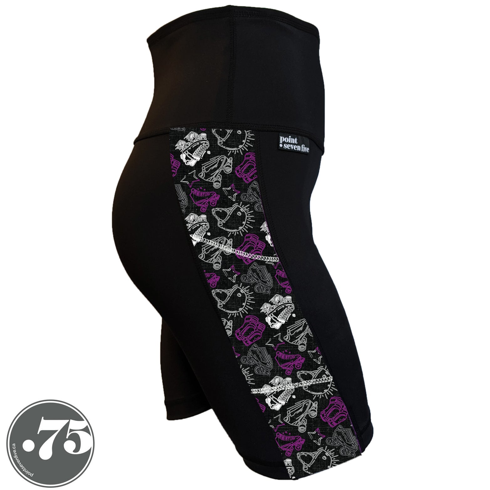 A pair of black spandex skate length shorts on a mannequin, the leggings have a 3.5” wide stripe down the side that has a printed fabric with rollerskates, helmets, stars & knee pads. The graphics are in the colours of the Ace Pride Flag, Black, Grey, White & Purple.