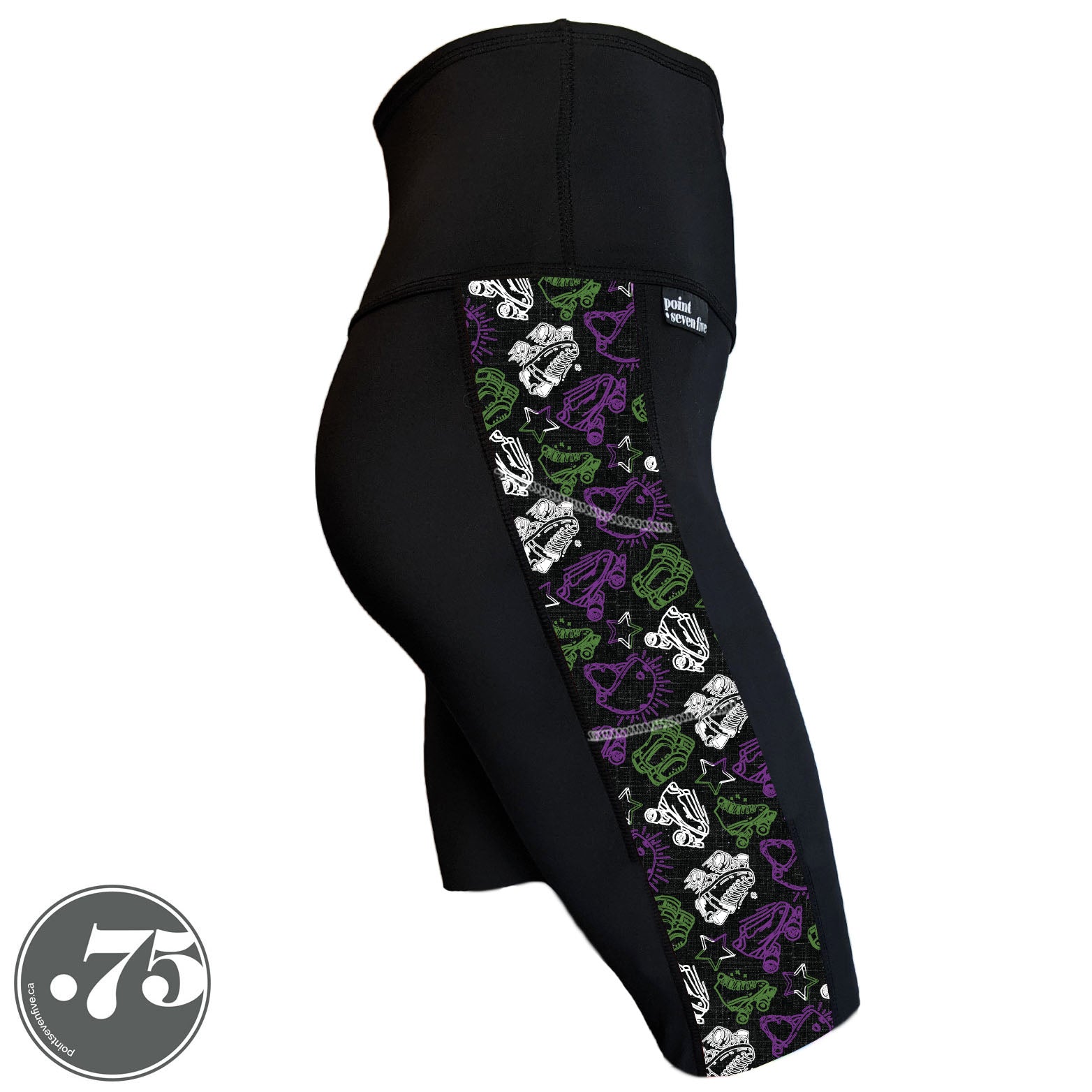 A pair of black spandex knee length shorts on a mannequin, the leggings have a 3.5” wide stripe down the side that has a printed fabric with rollerskates, helmets, stars & knee pads. The graphics are in the colours of the Genderqueer Pride Flag green, purple and white. 