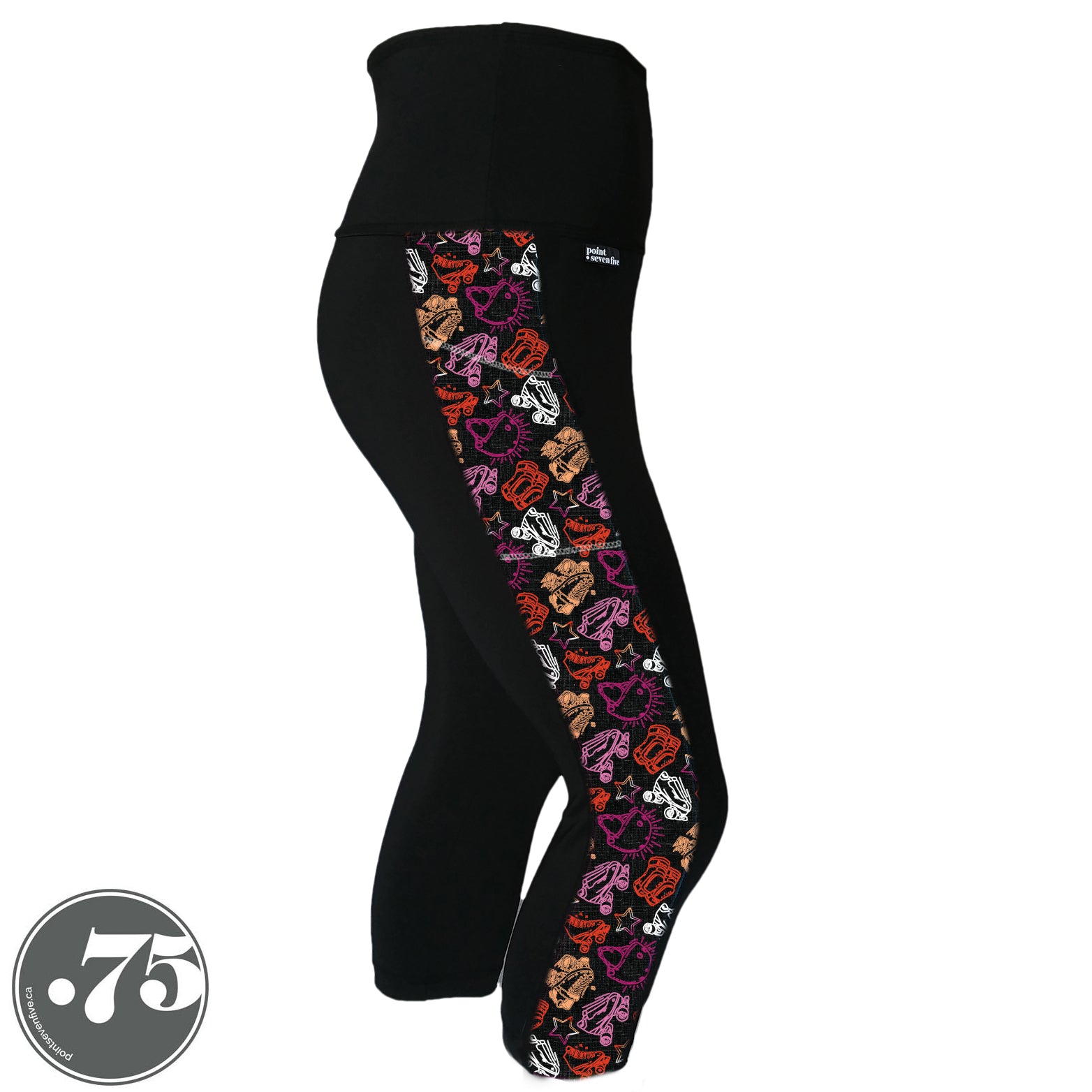 A pair of black spandex capri leggings on a mannequin, the leggings have a 3.5” wide stripe down the side that has a printed fabric with rollerskates, helmets, stars & knee pads. The graphics are in the colours of the Lesbian Pride Flag Colours orange, light orange, white, light pink and dark pink.