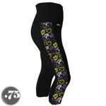 Load image into Gallery viewer, A pair of black spandex capri leggings on a mannequin, the leggings have a 3.5” wide stripe down the side that has a printed fabric with rollerskates, helmets, stars &amp; knee pads. The graphics are in the colours of the Non-Binary Pride Flag, white, black, purple and yellow. 
