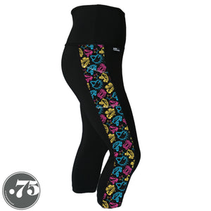 A pair of black spandex capri leggings on a mannequin, the leggings have a 3.5” wide stripe down the side that has a printed fabric with rollerskates, helmets, stars & knee pads. The graphics are in the colours of the Pan Pride Flag pink, blue and  yellow.  