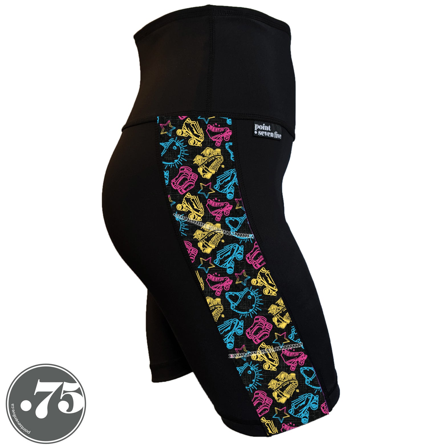 A pair of black spandex skate length shorts on a mannequin, the leggings have a 3.5” wide stripe down the side that has a printed fabric with rollerskates, helmets, stars & knee pads. The graphics are in the colours of the Pan Pride Flag pink, blue and  yellow.  
