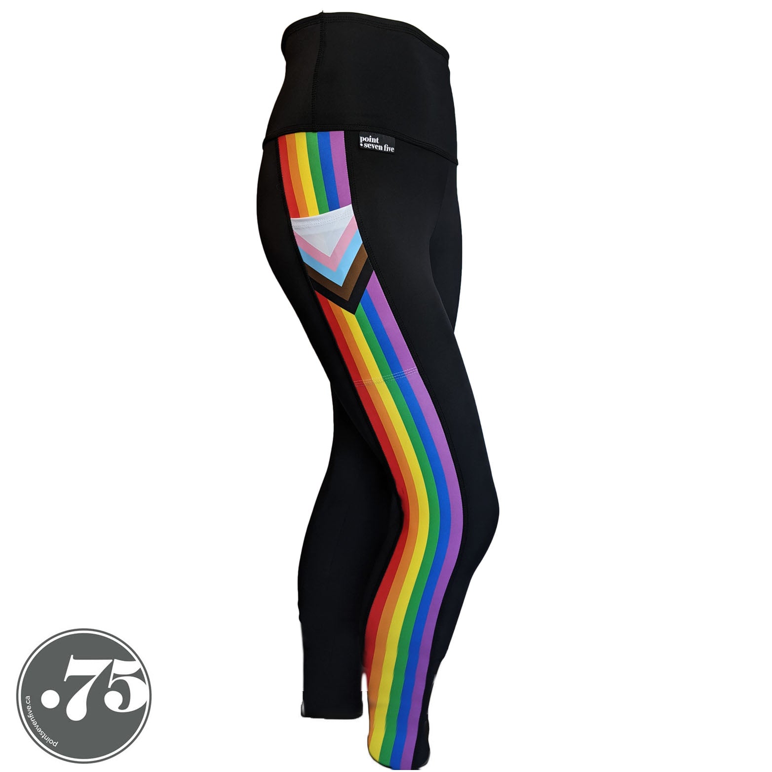 A pair of black spandex leggings on a mannequin, the leggings have a 3.5” wide stripe down the side that has a printed fabric with the stripes of the Progress Pride Flag vertically and the are chevrons placed at the top of the pocket. The stripes are red, orange, yellow, green, blue and purple. The chevrons are white, pink, light blue, brown and black and point down from the top of the pocket. 